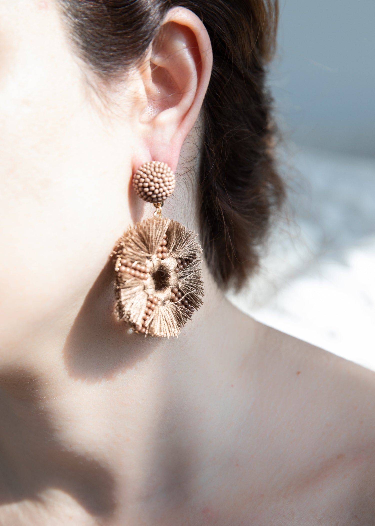 Stylish accessories with a purpose including handbags, hats, sunglasses, and shoes on a wooden surface